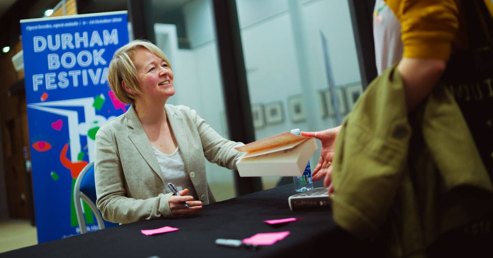 author signing a book at Durham Book Festival